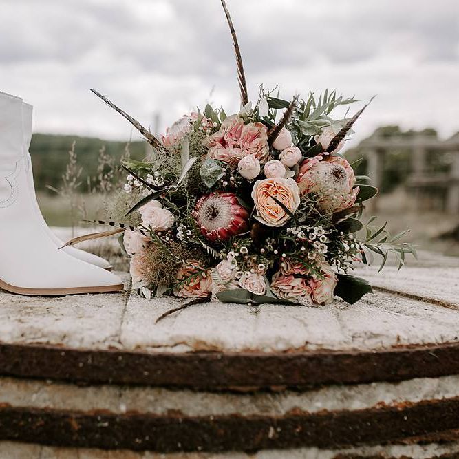 Protea bouquet with white bridal boots