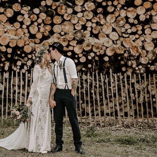 Bride clutches Protea bouquet as she kisses new husband
