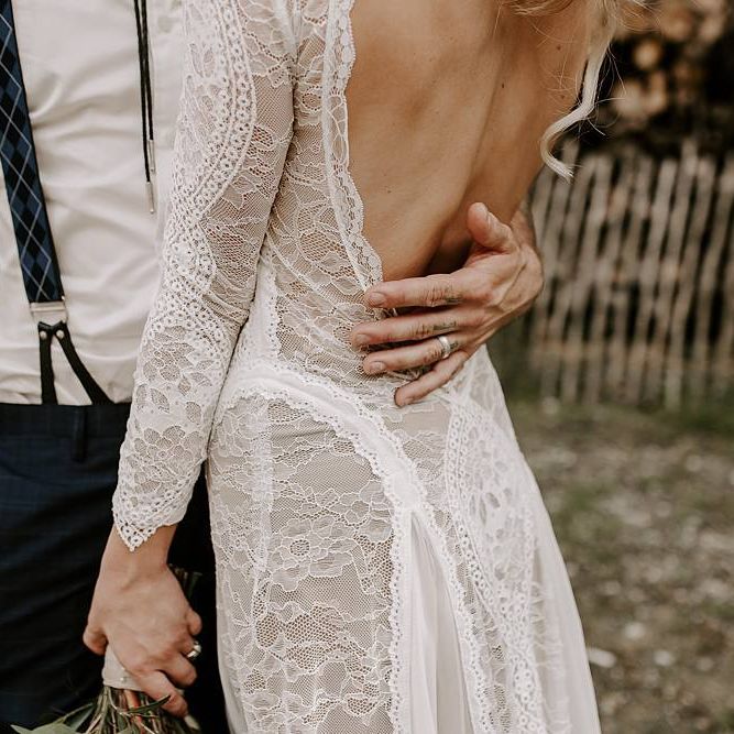 Low back lace detail wedding dress with Protea bouquet