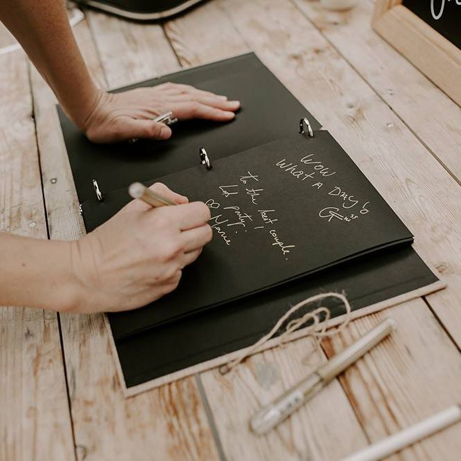 Guests sign the wedding guest book