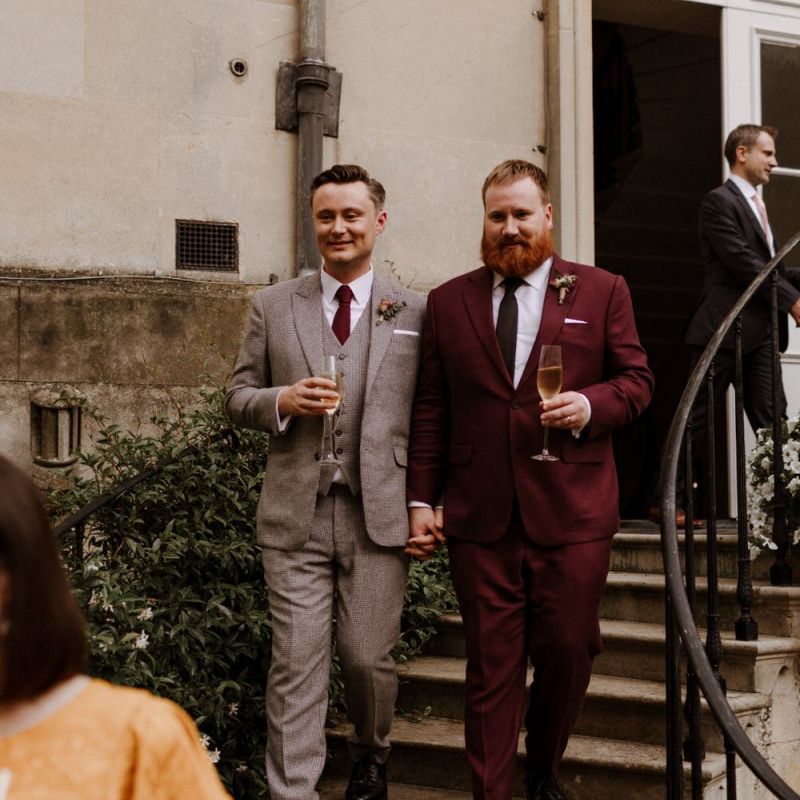 Grooms in burgundy and beige checked suits at Syon Park