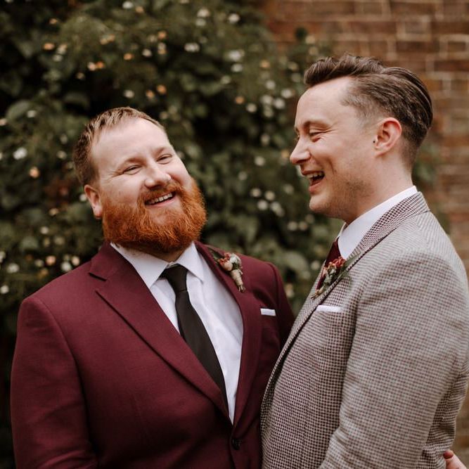 Wedding portrait of groom and groom laughing