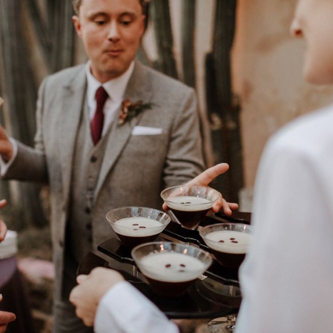 Groom and groom enjoying expresso martini cocktails at Syon Park wedding