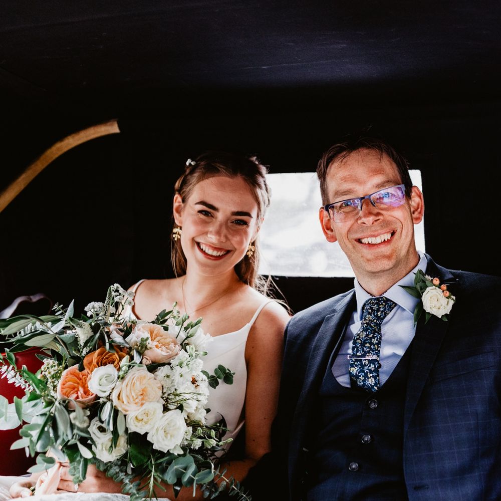 Bride and groom arrival in vintage wedding car