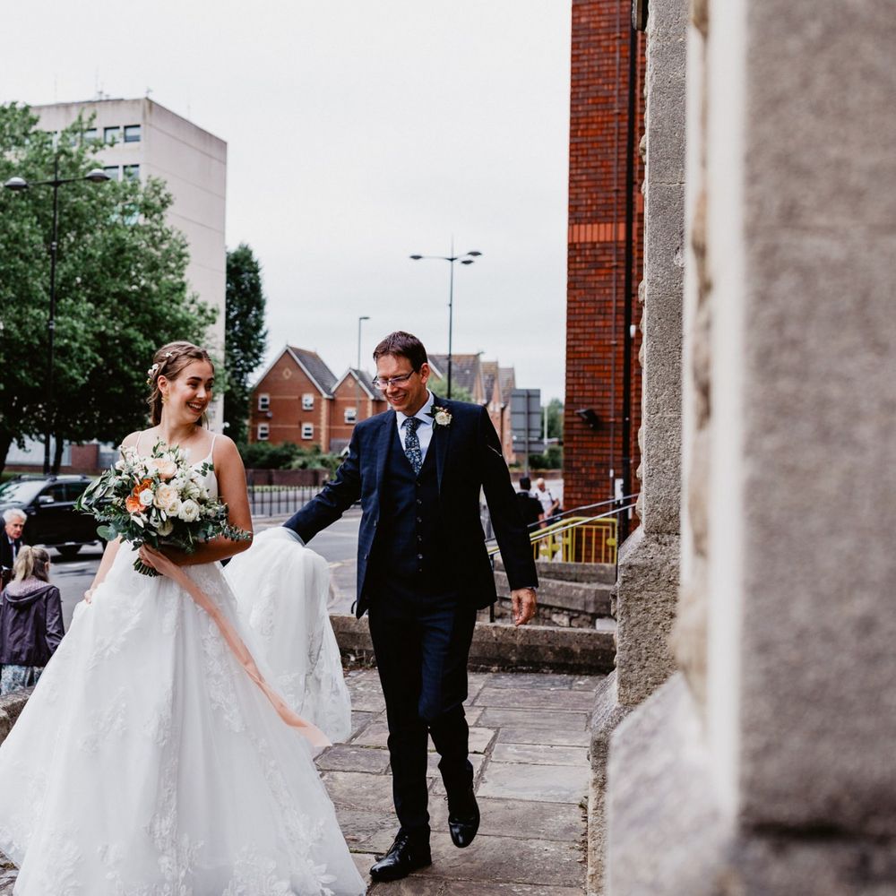 Bride outside the church in Essense of Australia wedding dress