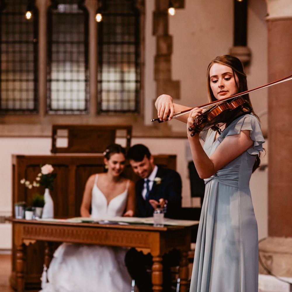 Violin playing whilst the bride and groom sign the register