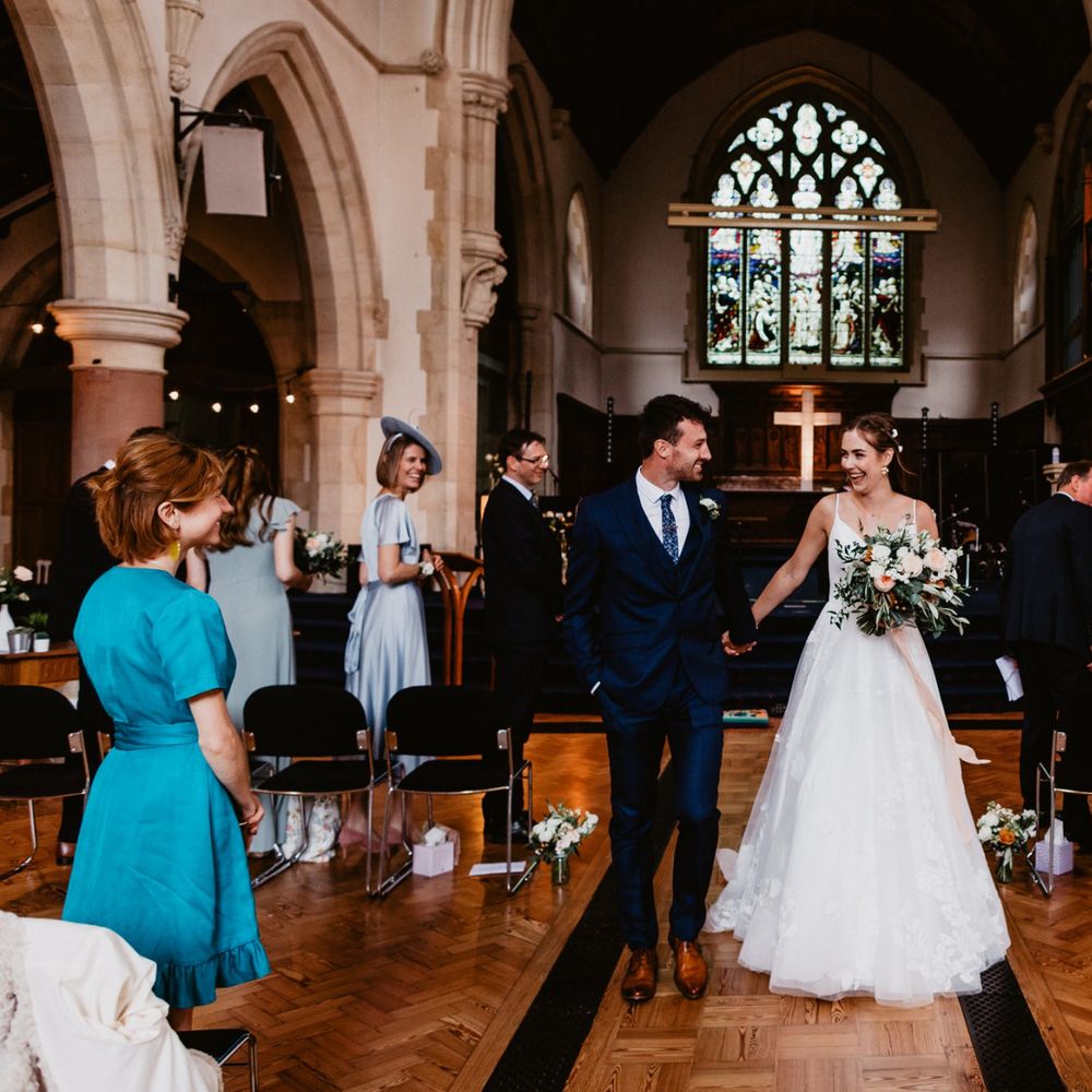 Bride and groom walking up the aisle as husband and wife