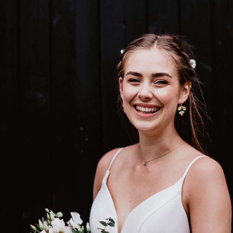 Beautiful bride in thin strap wedding dress