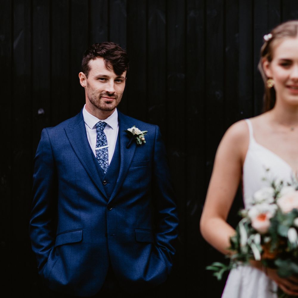 Wedding photography with groom in focus