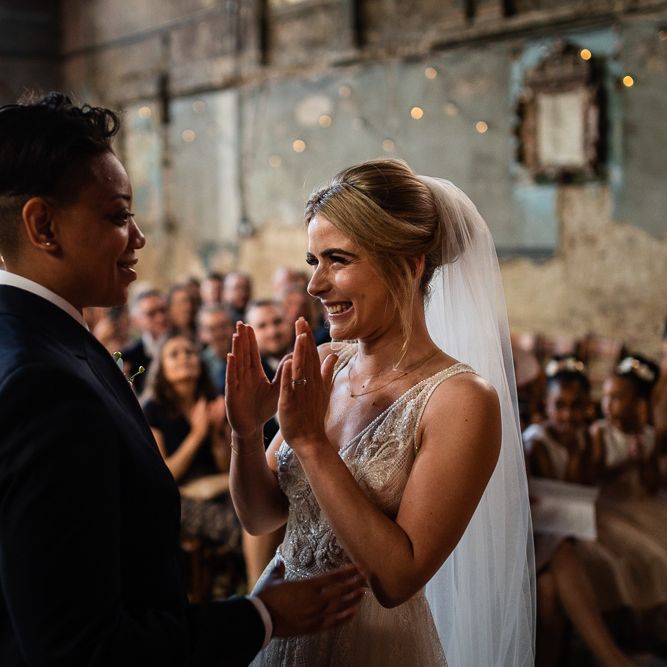 Wedding Ceremony at The Asylum with Bride in Navy Suit and Pink Tie and Excited Bride in Romantic Flora Mila Wedding Dress