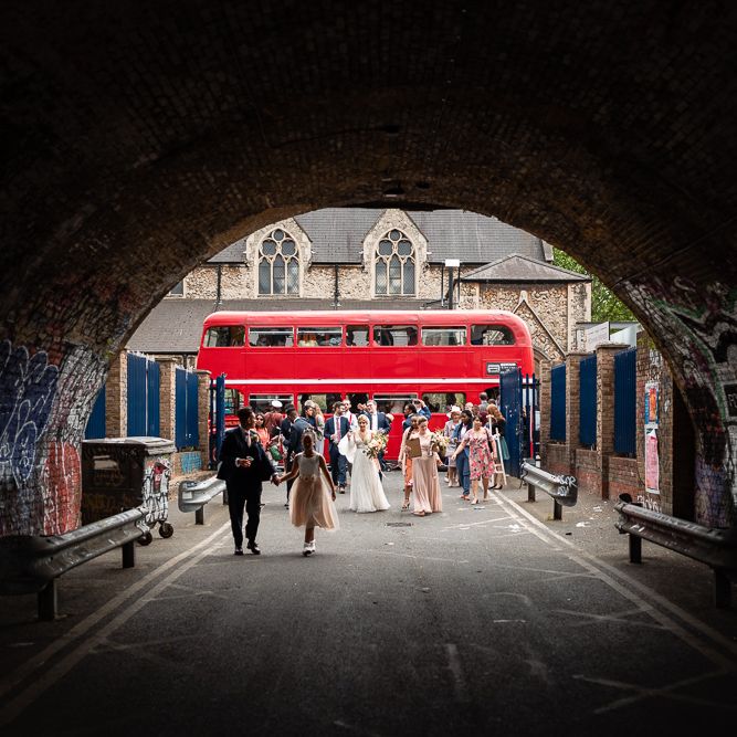Wedding Guests Getting off the Red Double Decker Bus Wedding Transport