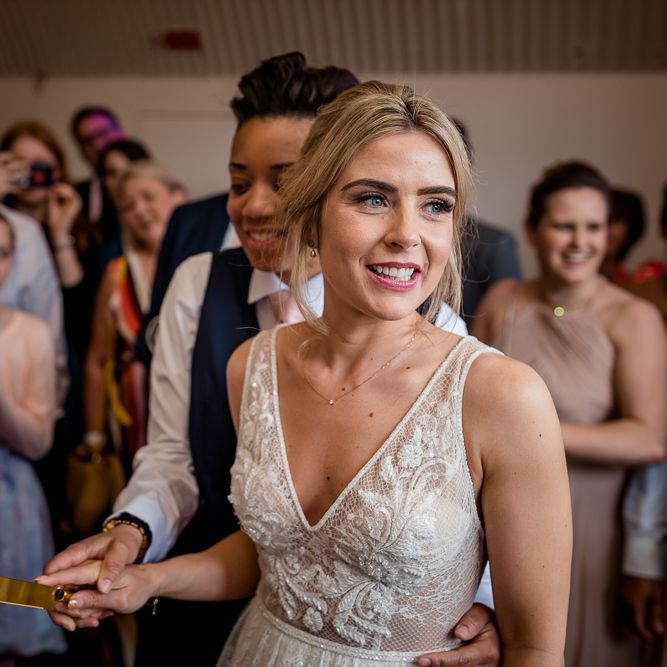 Two Brides Cutting the Traditional Wedding Cake