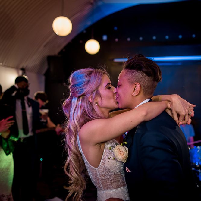 Bride and Bride Kissing on the Dance Floor During First Dance