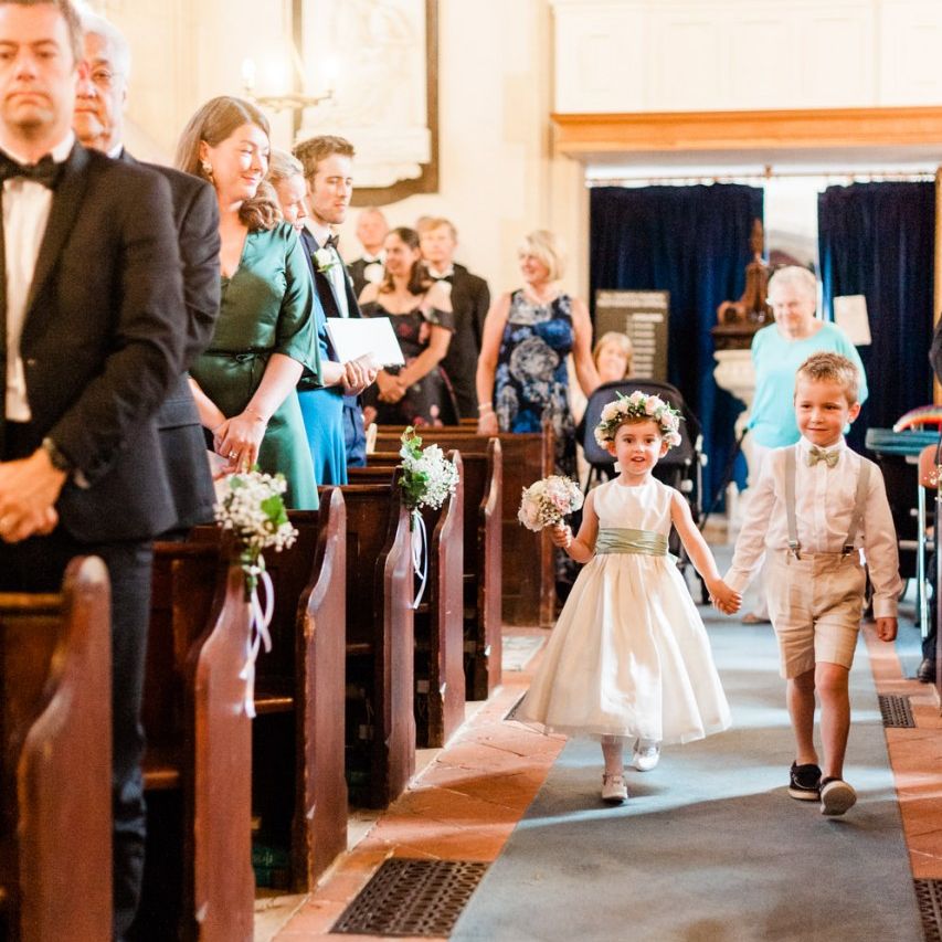 Bridesmaid and page boy walk down the aisle