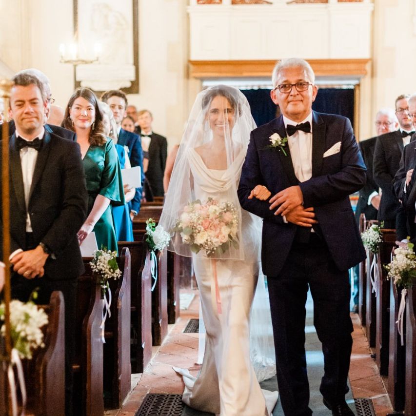 Bride walks down the aisle at church ceremony