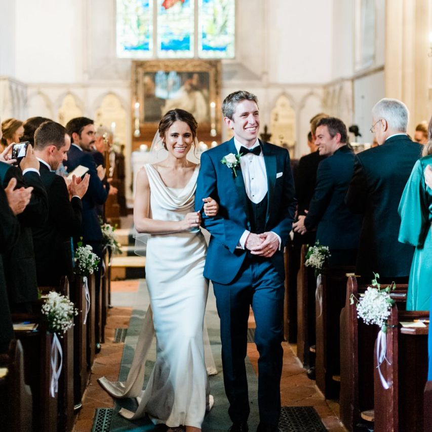Bride and groom walk down the aisle as husband and wife