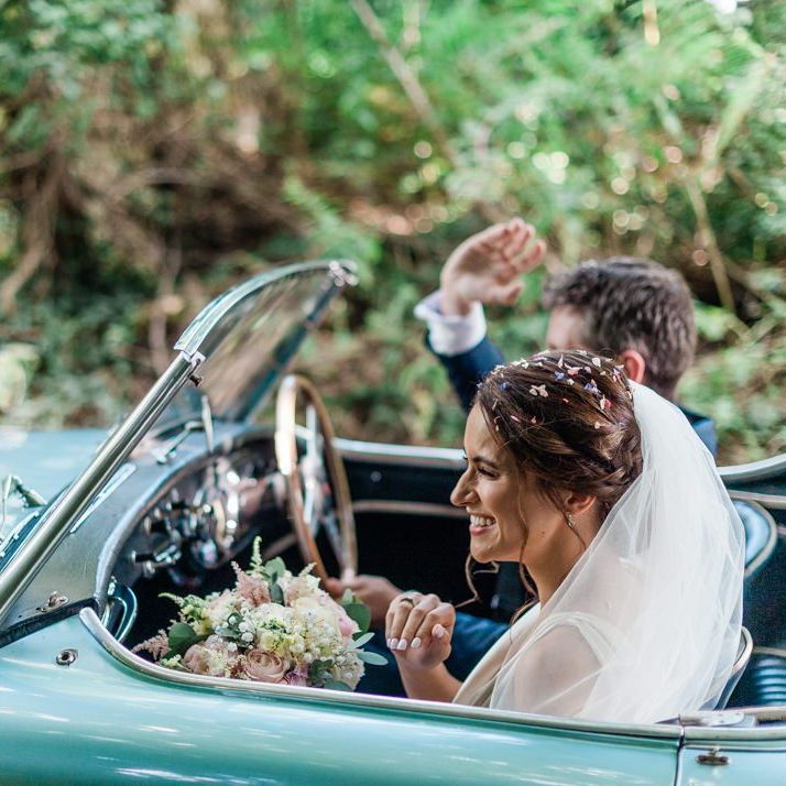 Bride and groom in vintage wedding car on their way to Four Seasons Hampshire