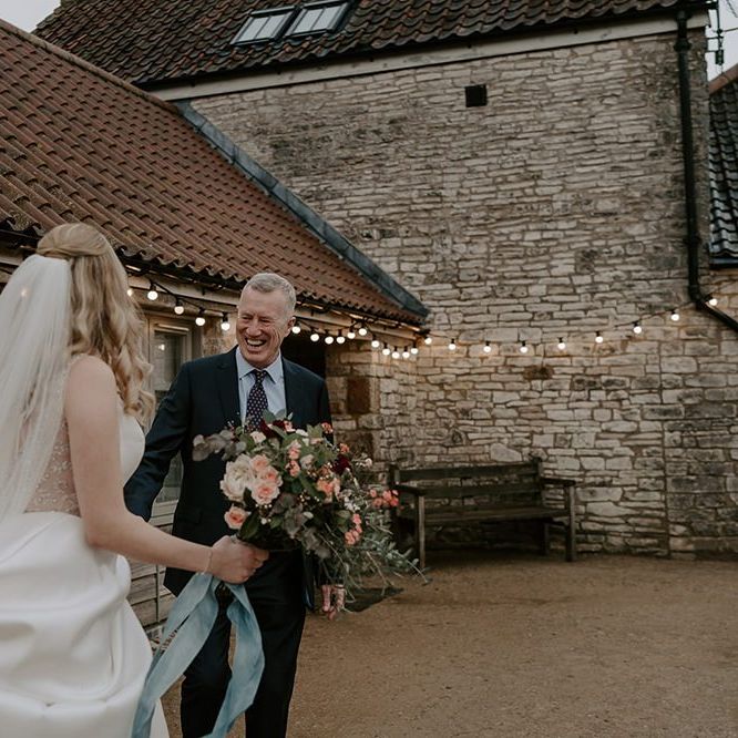 Bride wears veil as she makes her way to the ceremony