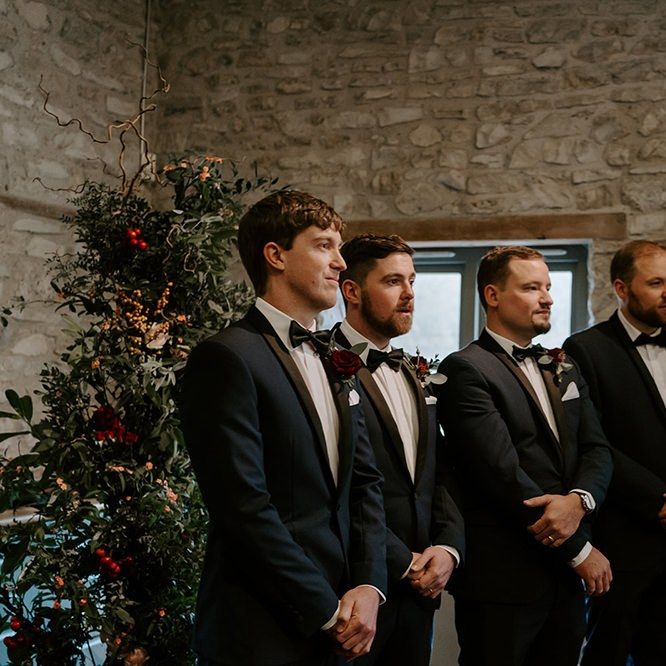 Groom with groomsmen as they wait for bride's arrival