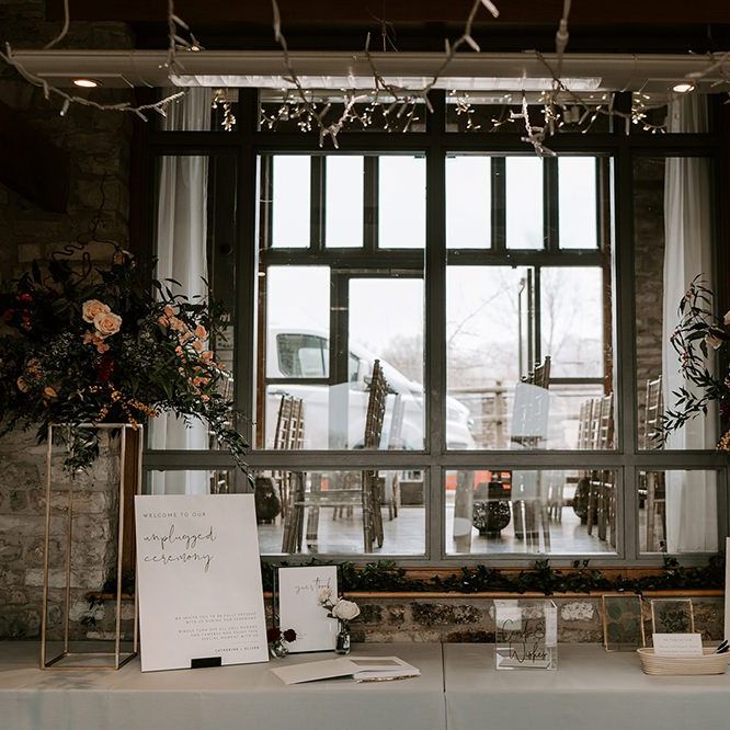 Unplugged wedding sign on card table at Winter wedding