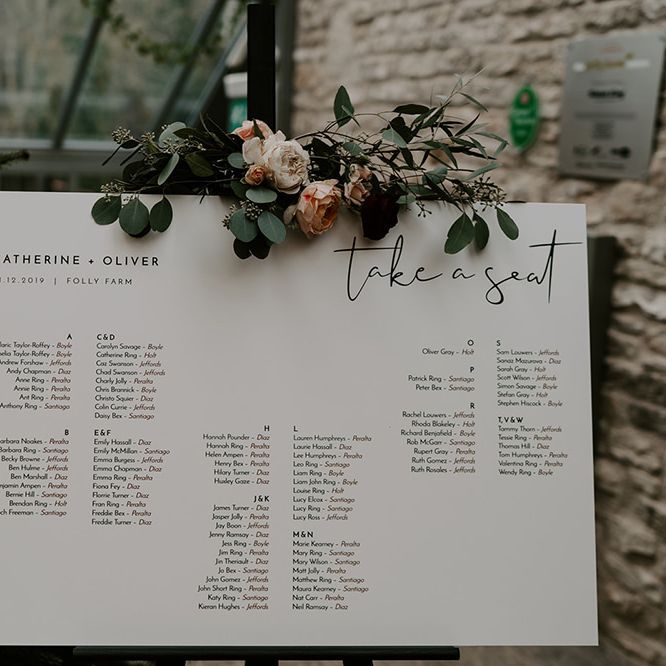 Wedding table plan and unplugged wedding sign decorated in flowers