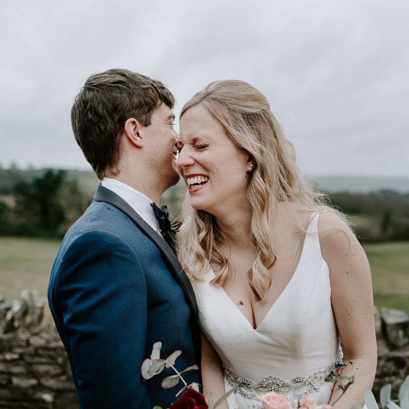 Bride and groom at Winter wedding with unplugged wedding sign