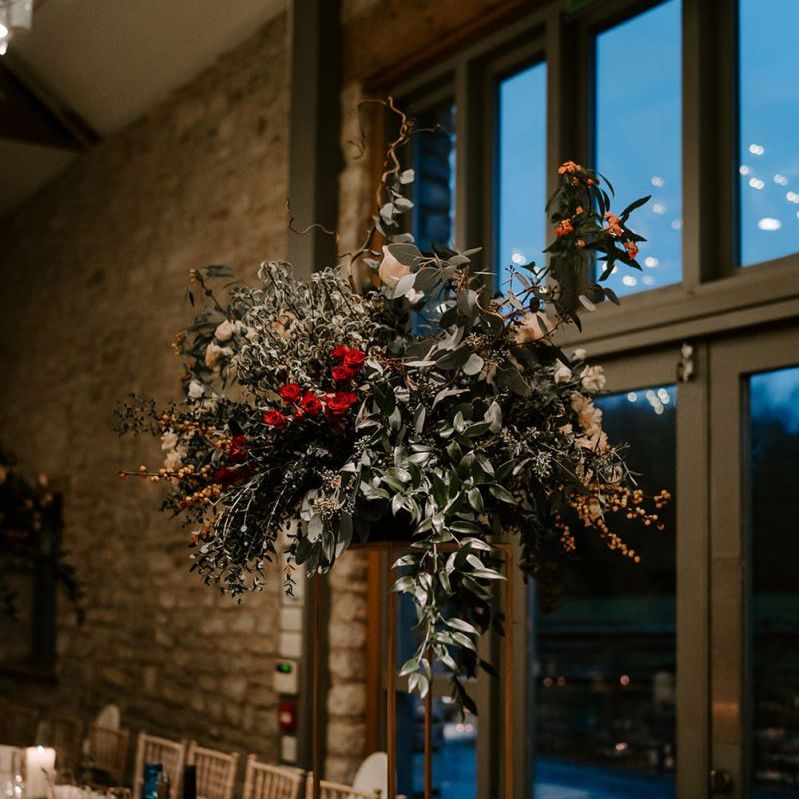 Tall flower centrepieces for tables at Winter wedding