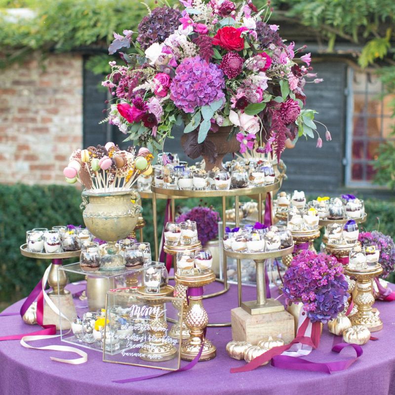Dessert Table with Purple Table Cloth and Wedding Flowers