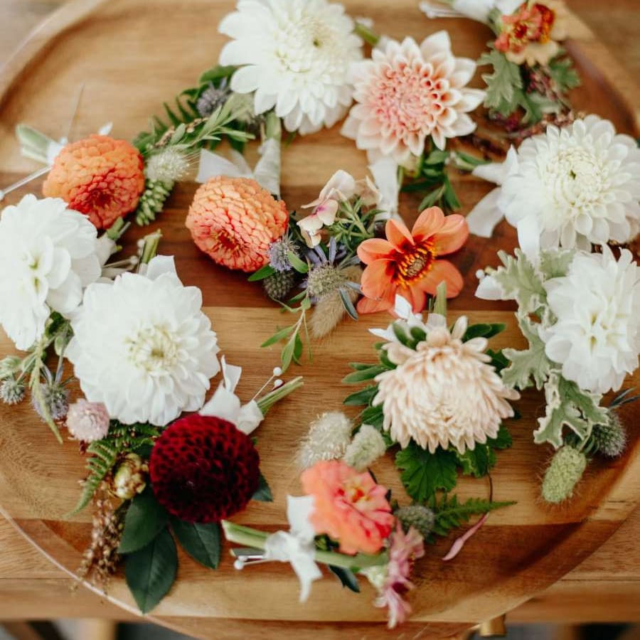 Dahlia buttonholes in peach and white