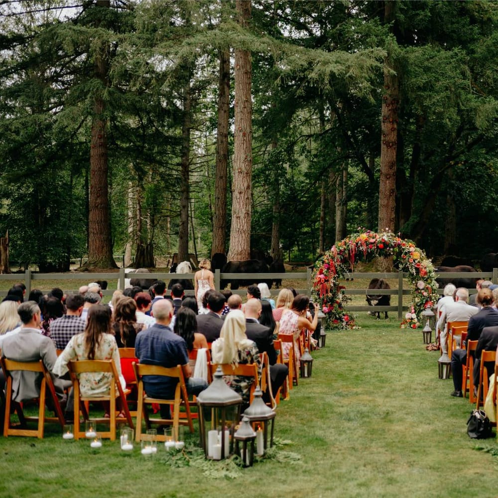 Outdoor wedding ceremony at Mystique Ranch with flower arch