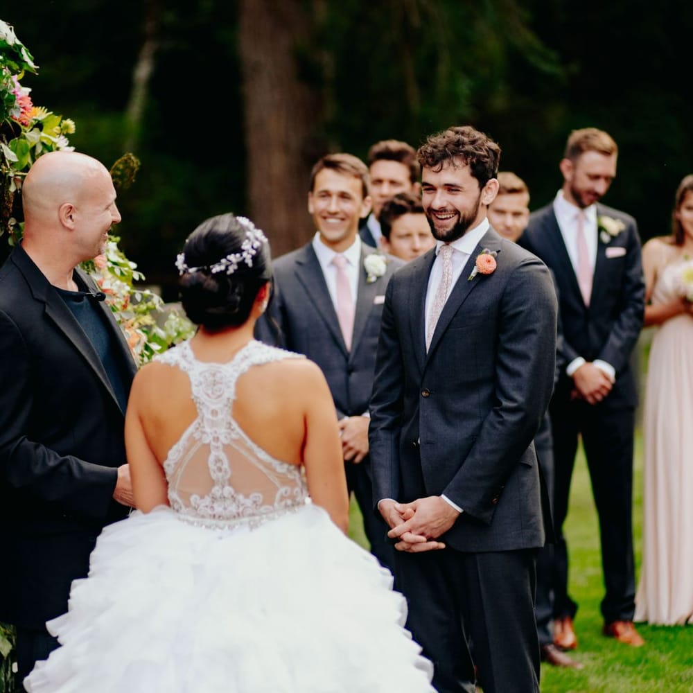 Bride in racer back wedding dress saying her vows