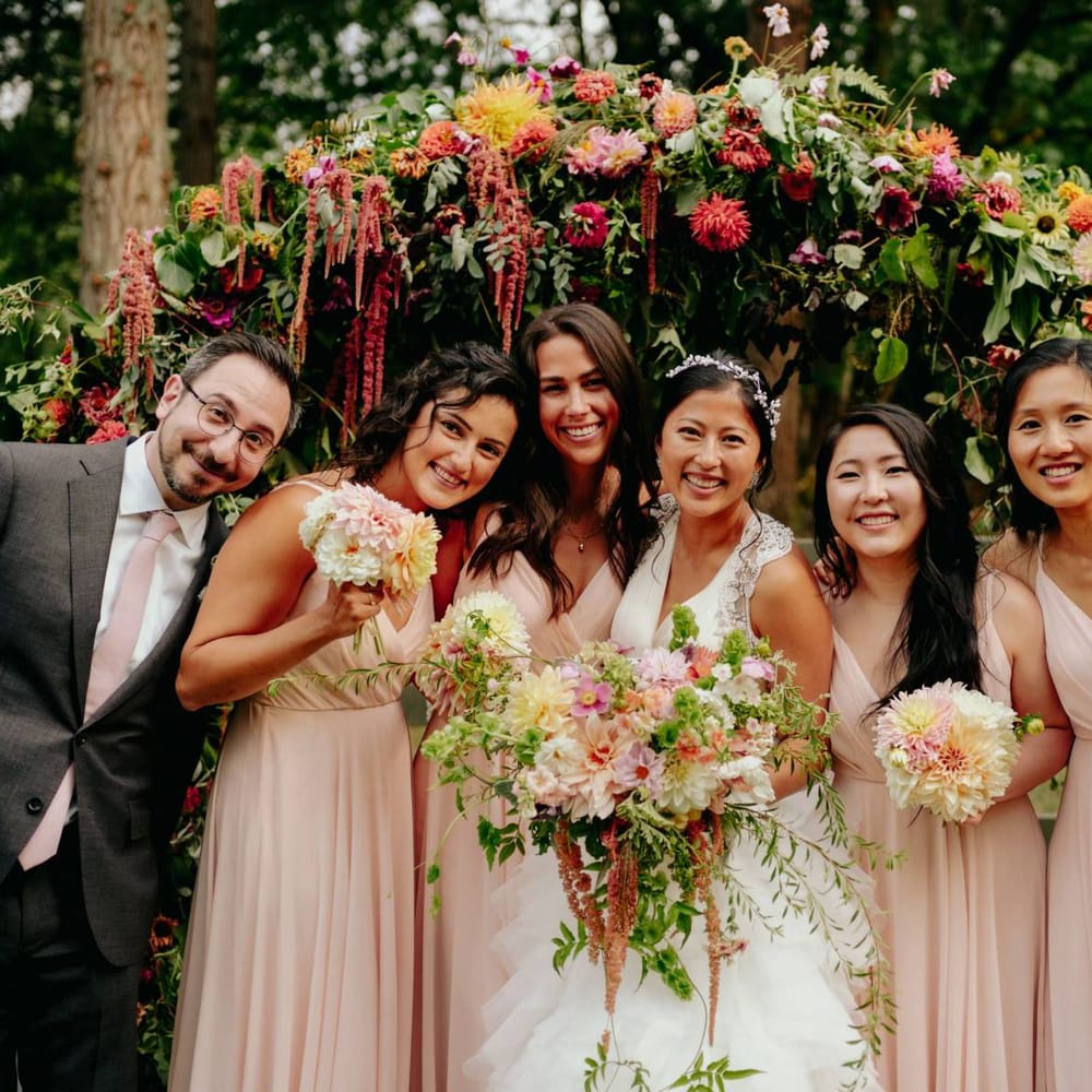 Bridal party portrait with bridesmaids in pink dresses
