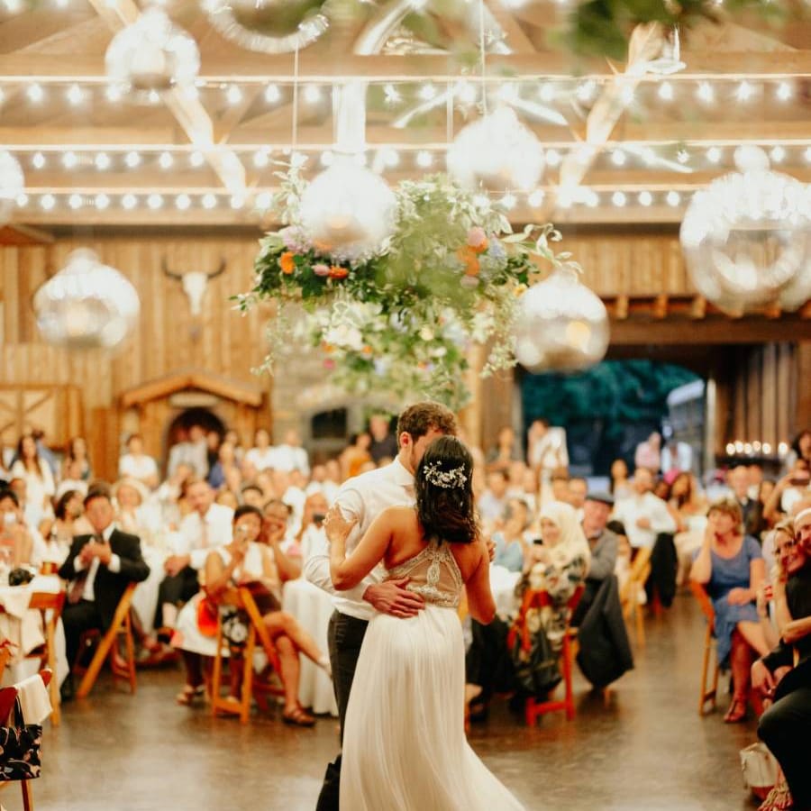Bride and groom first dance with bride in racerback wedding dress
