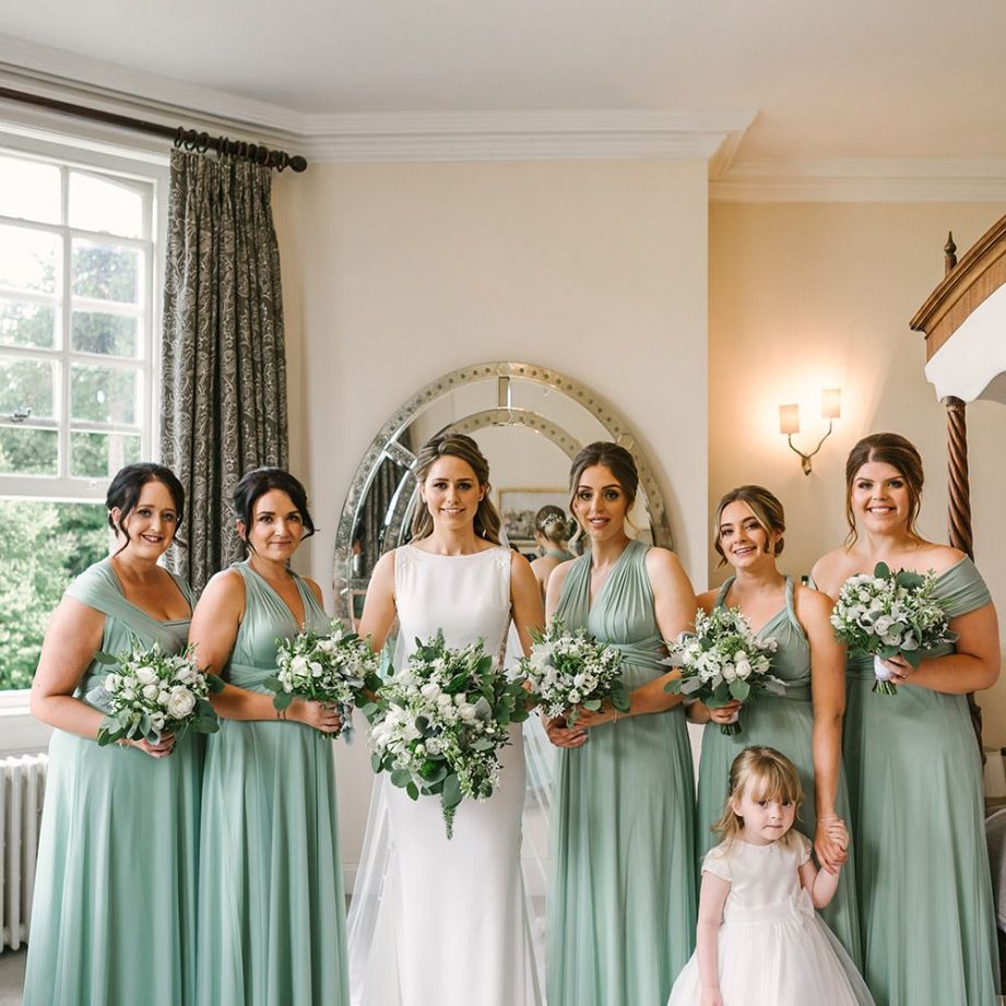 Bridal Party Portrait with Bridesmaids in Pale Green Multiway Dresses and Bride in Pronovias Wedding Dress
