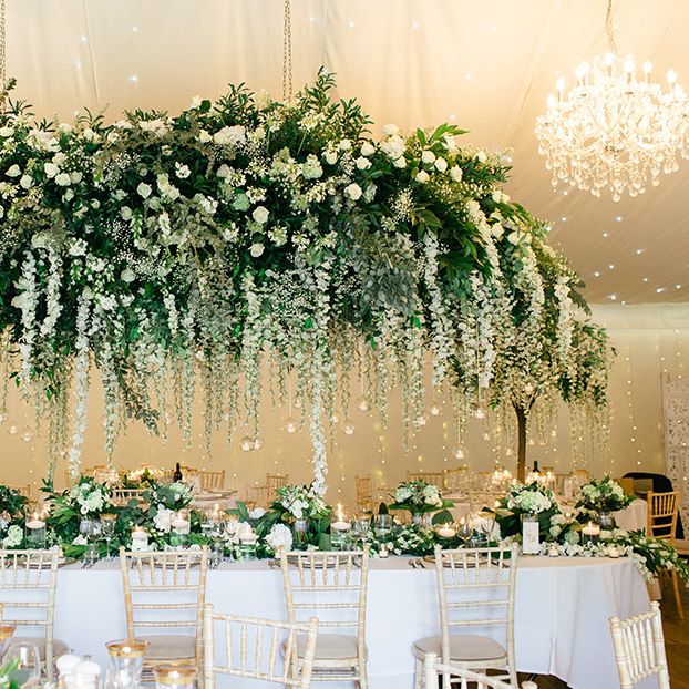 White Flower and Green Foliage Floral Installation Over the Top Table by Red Floral Architecture