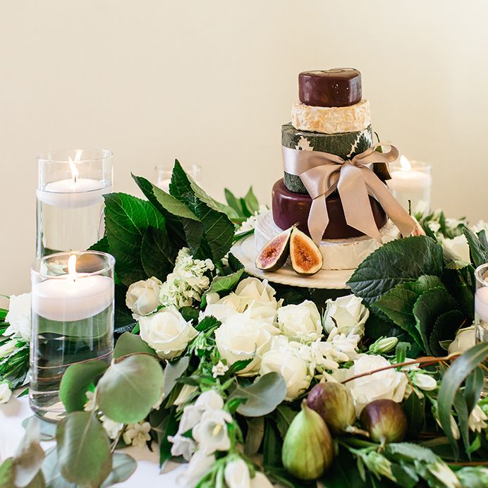 Cheese Tower Surrounded by White Flowers, Foliage and Candles