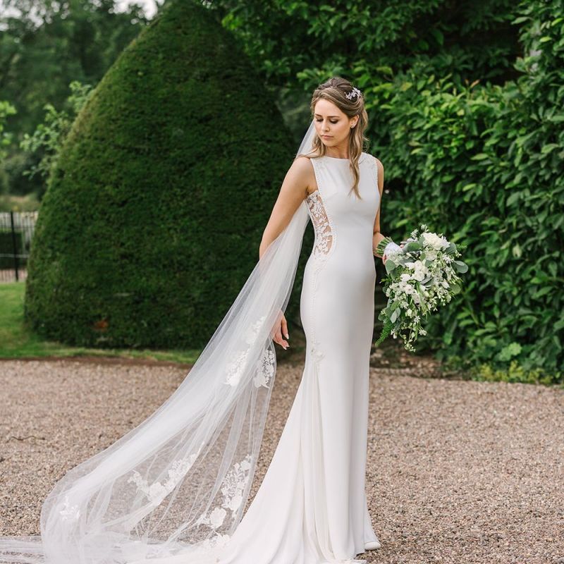 Classic Bride in Fitted Pronovias Wedding Dress with Lace Side Inserts