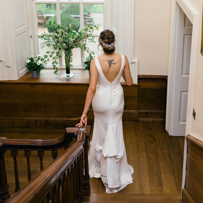 Bride in Fitted Pronovias Wedding Dress with Buttons Down the Back