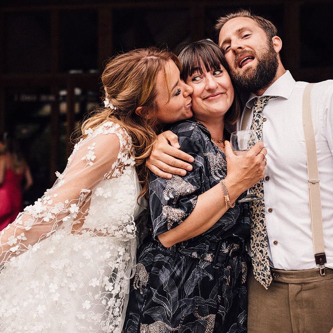 Bride and groom pose with wedding guests at Nancarrow Farm