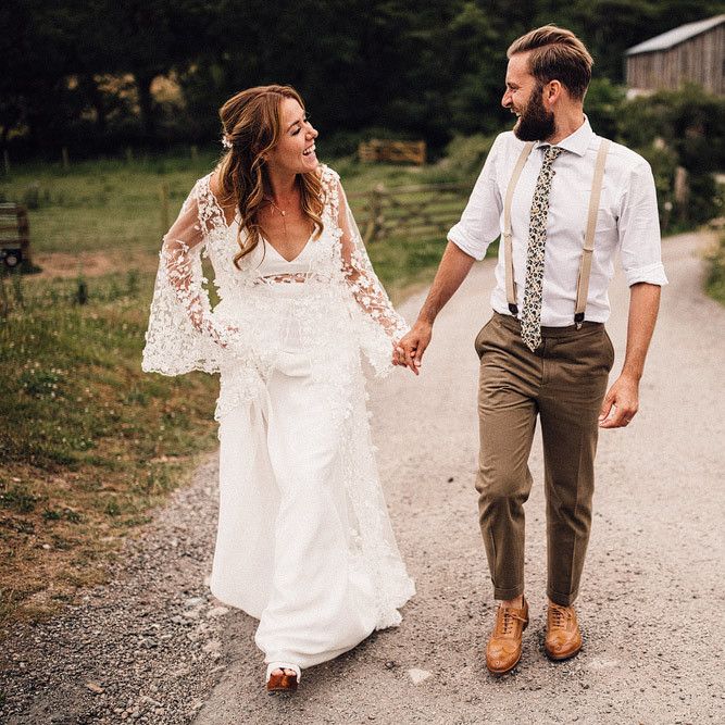 Bride and groom wander through the grounds of Cornwall wedding venue