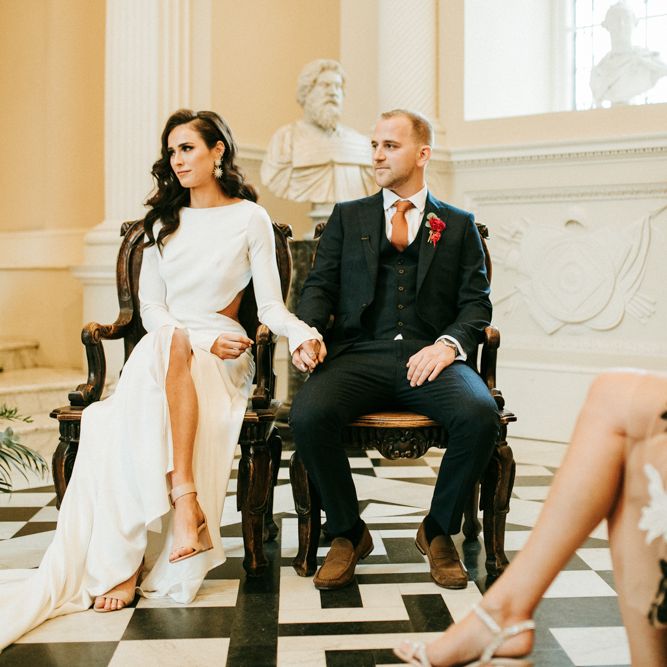 Bride and Groom Holding Hands During The Wedding Ceremony