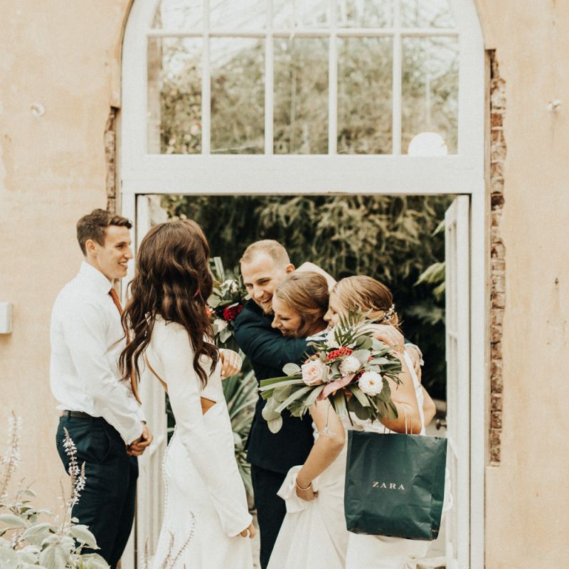Bride and Groom Embracing Wedding Guests