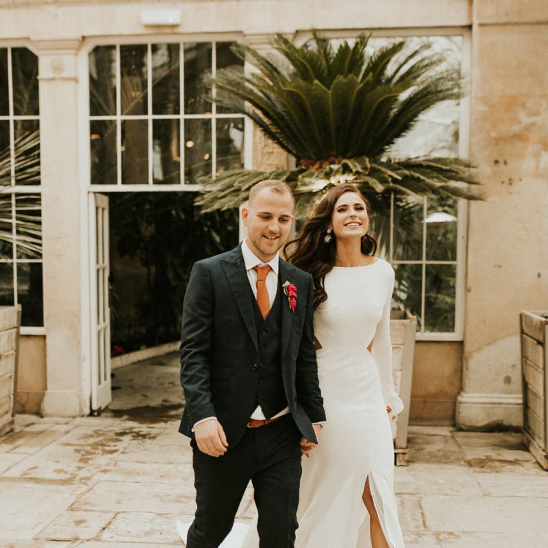 Groom and Bride in Front Split Wedding Dress Walking into the Wedding Reception