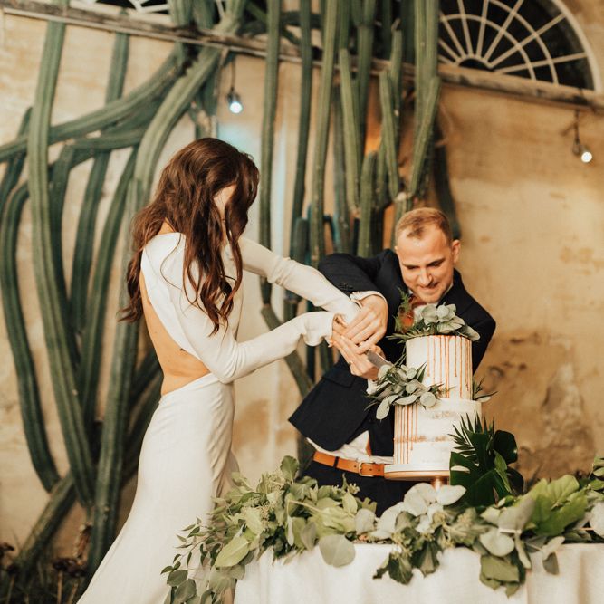 Bride and Groom Cutting The Wedding Cake