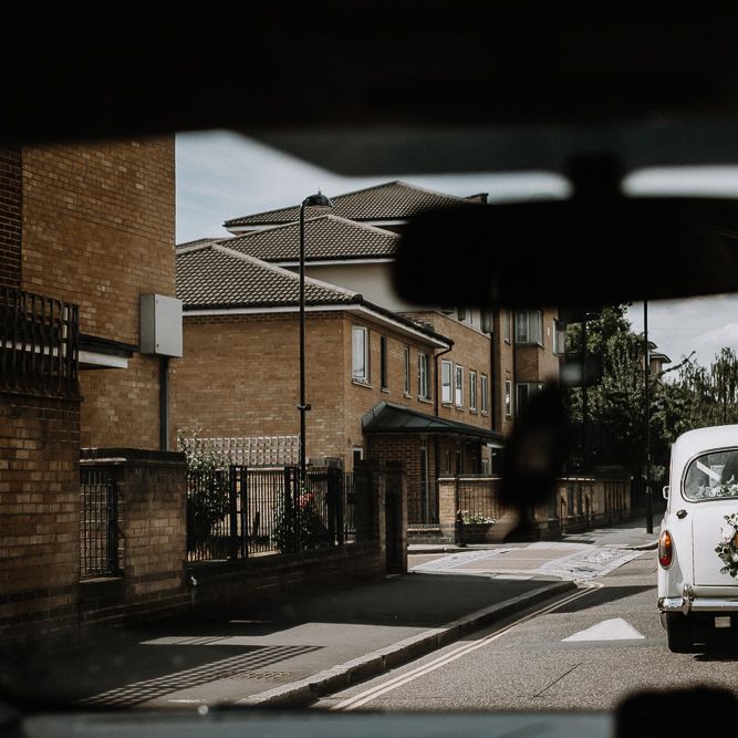 White Wedding Car with Flower Garland and Ribbons | Floral Arch and Bride in Batwing Sleeve Halfpenny Dress for London Pub Wedding | Caitlin + Jones