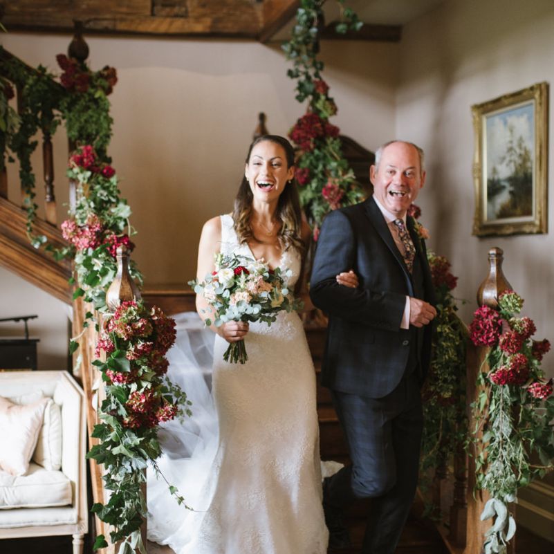Bride and Father of The Bride Walk Down the Floral Decorated Staircase