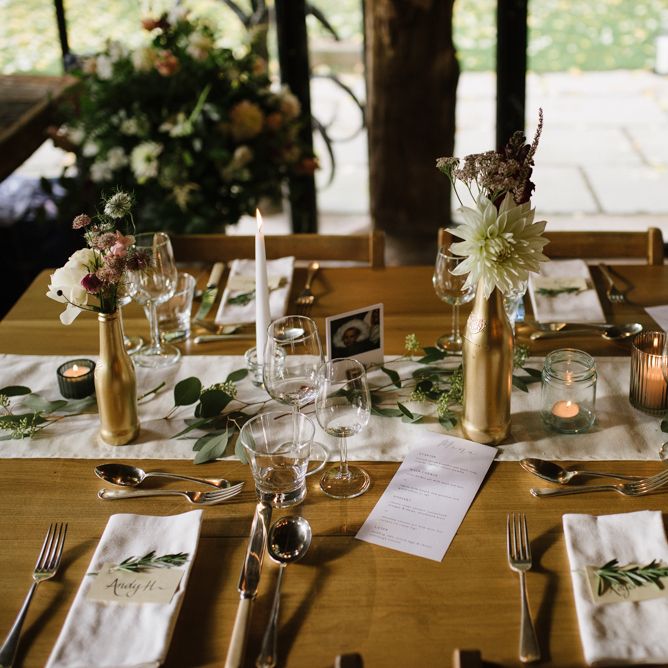 Wedding Reception Table Decor with Gold Spray Painted Bottles, Candle Light and Greenery Decor