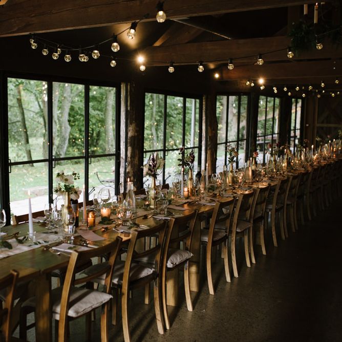 Barn Wedding Reception Decor with Festoon Lights and Candles