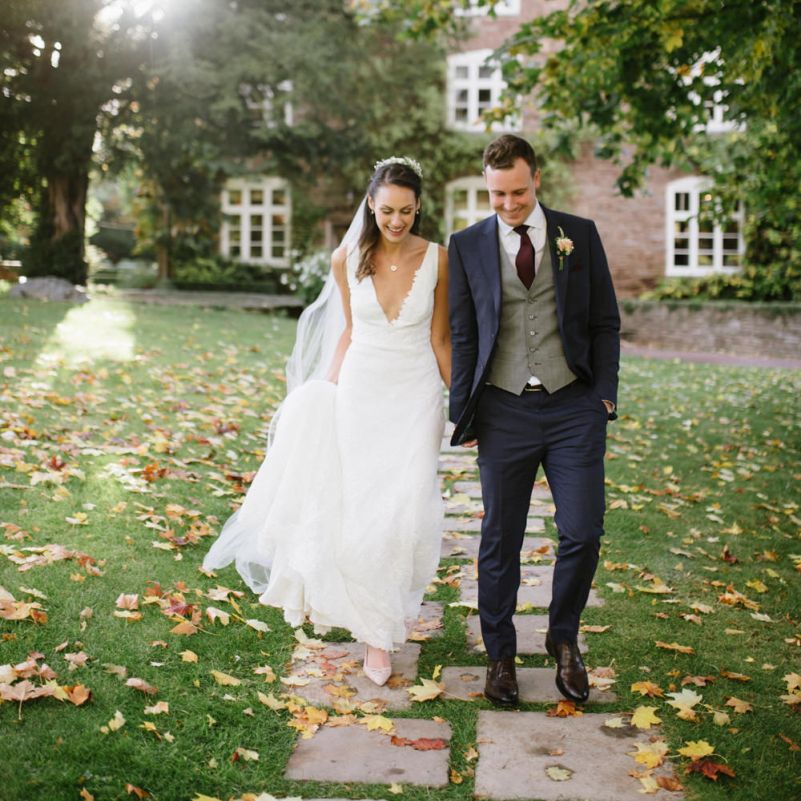 Bride and Groom Wedding Portrait with Autumn Leaves on the Floor