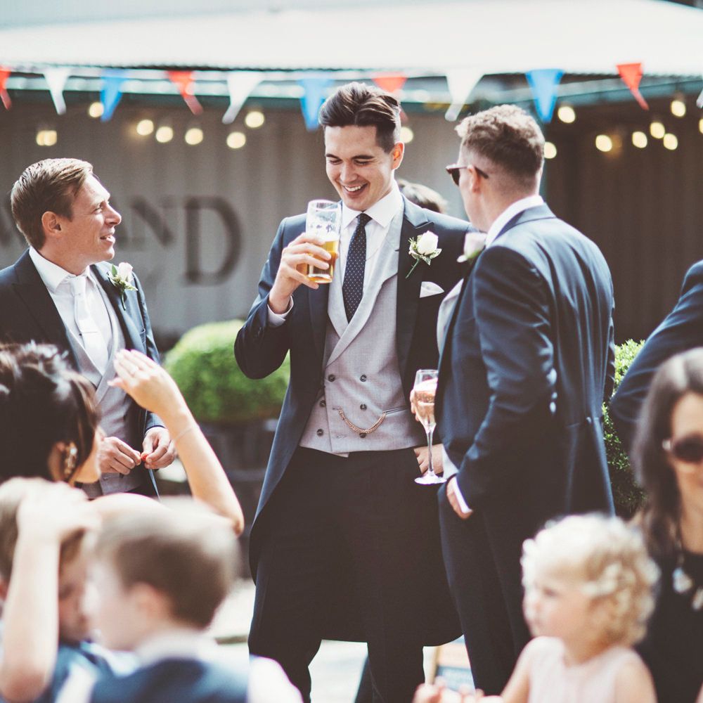 Pre-Ceremony Pint | Groom in Navy Tails and Grey Waistcoat | Lace Bridal Cape Veil &amp; Fishtail Wedding Dress by Pronovias | On Love and Photography